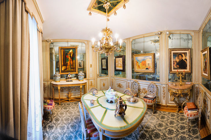 Paintings by De Chirico hang in the mirrored dining room of Francesco Federico Cerruti's villa. Photo: Gabriele Gaidano