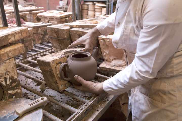 Ian McIntyre removing a Brown Betty from a mould. Photo: Glen Stoker
