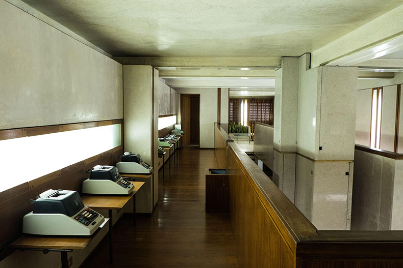 A showroom with typewriters on wooden shelves