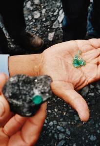 Raw emeralds in the hands of market traders in Colombia.