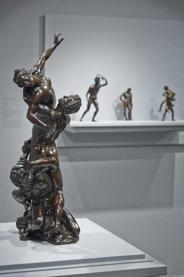 Antonio Susini’s 'Rape of a Sabine' in the foreground, and in the background, Riccio’s 'Strigil Bearer' and other early Italian bronzes from the collection of Mr. and Mrs. J. Tomilson Hill.