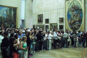 Crowds gather around the Mona Lisa in the Louvre.