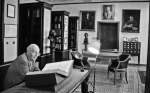 William Scheide reads in the Scheide Library. This space created at Princeton's Firestone Library includes furniture, statues, rugs and leaded-glass windowpanes from the original library built by his father in Titusville, Pennsylvania. Photo by Natasha D'Schommer