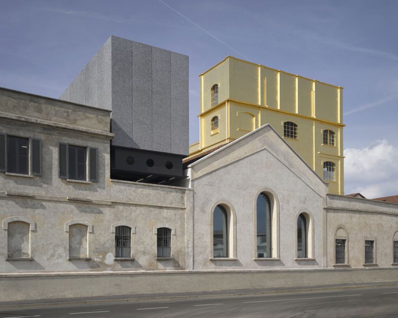 Exterior view of the Fondazione Prada in Milan, designed by Rem Koolhaas and OMA, showing a pre-existing tower covered in 24-carat gold leaf.