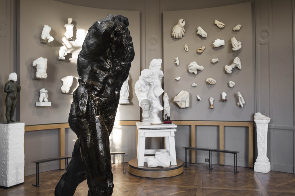 Installation view showing Rodin's The Walking Man (1907) with pieces from the sculptor's collection of antiquities
