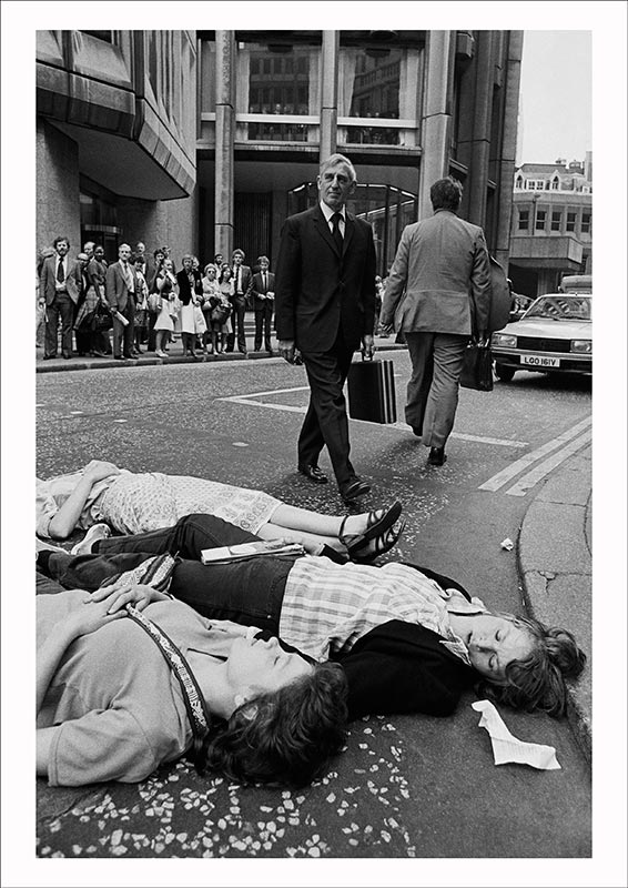 Greenham Common protesters stage a Die-in outside the Stock Exchange during the morning rush hour as U.S. President Reagan arrives in Britain, City of London (1982), Edward Barber