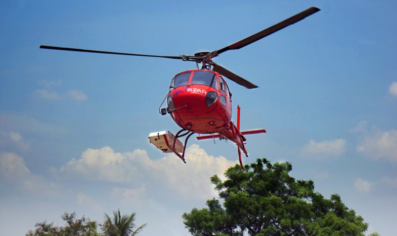 The helicopter during the 2015 flight operations, with the lidar instrument mounted within a pod on the right-hand skid.