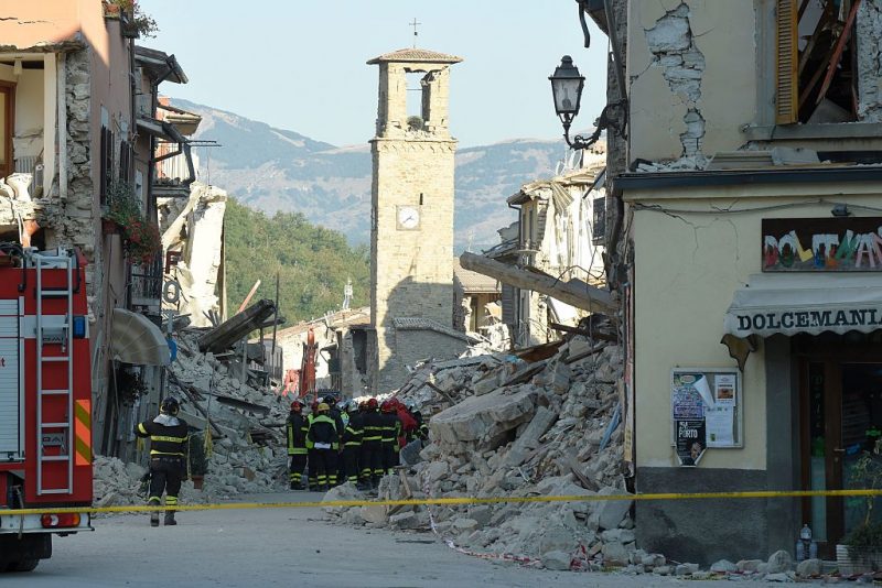 Firefighters gather near the damaged Sant'Agostino church in the central Italian village of Amatrice on 26 August, 2016, three days after a 6.2-magnitude earthquake struck the region. ANDREAS SOLARO/AFP/Getty Images