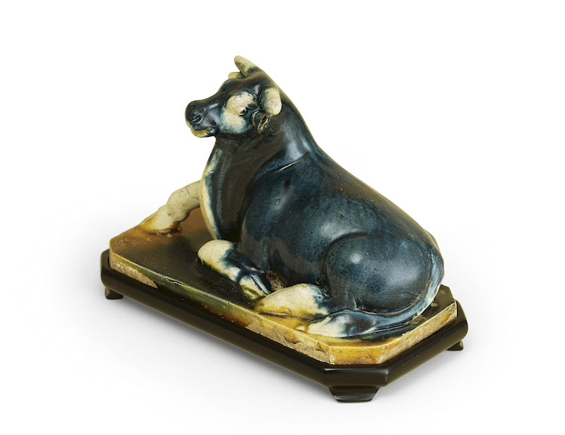 A blue straw- and amber-glazed model of a recumbent buffalo (8th century), China, Tang Dynasty. 