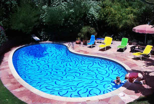 David Hockney with a model in the pool