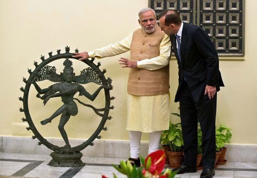 Indian Prime Minister Narendra Modi and Australian Prime Minister Tony Abbott talk alongside a statue of the Dancing Shiva ahead of a meeting in New Delhi, 5 September, 2014. The $5 million bronze statue was returned to India from the National Gallery of Australia after it emerged that it had been stolen from a Tamil Nadu temple. PRAKASH SINGH/AFP/Getty Images)