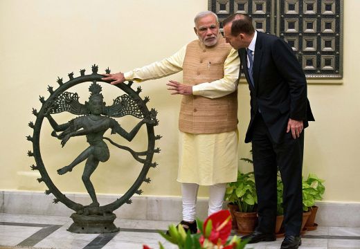 Indian Prime Minister Narendra Modi and Australian Prime Minister Tony Abbott talk alongside a statue of the Dancing Shiva ahead of a meeting in New Delhi, 5 September, 2014. The $5 million bronze statue was returned to India from the National Gallery of Australia after it emerged that it had been stolen from a Tamil Nadu temple. PRAKASH SINGH/AFP/Getty Images)