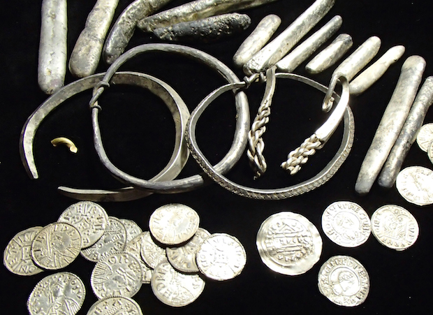 Selection of items from the Watlington Hoard showing the range of objects discovered: arm-rings, ingots, coins and cut-up pieces of silver and gold. © Trustees of the British Museum