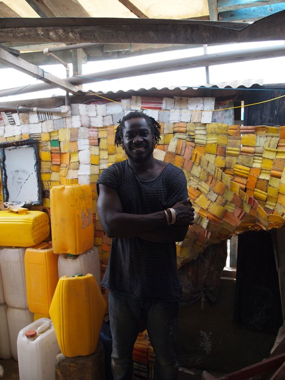 Serge Attukwei Clottey in his studio in front of some materials and unfinished works. Photo: Stephanie Dieckvoss