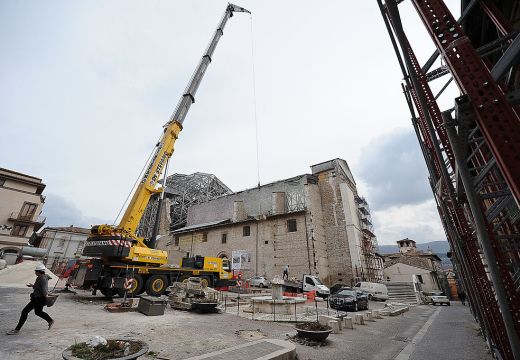 Apeopla pass on 2 April, 2012, by the Santa Maria Paganica church near the 'red zone' closed to public, in the historic area of L'Aquila devastated by the 2009 earthquake. ANDREAS SOLARO/AFP/Getty Images