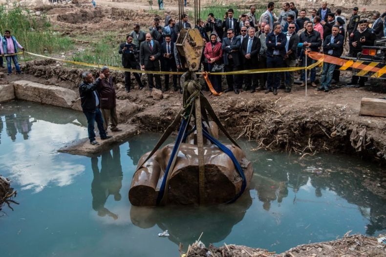 Egyptian workers excavate the statue, recently discovered by a team of German-Egyptian archeologists, in Cairo's Mattarya district on March 13, 2017.