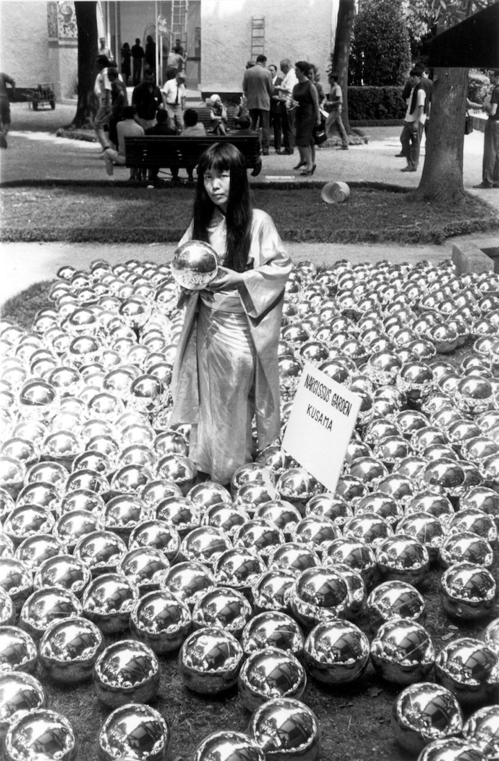 Photograph of Yayoi Kusama and her installation, Narcissus Garden in Venice, 1966. Collection of the Artist © Yayoi Kusama