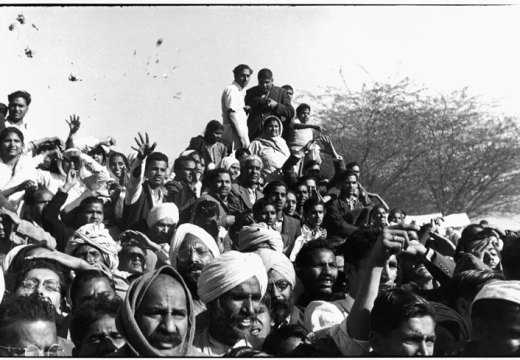 Gandhi's funeral. Crowds gathered between Birla House and the cremation ground, throwing flowers (1948), Henri Cartier-Bresson. © Henri Cartier-Bresson/Magnum Photos