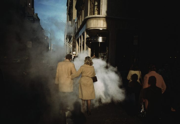 Camel Coat Couple in Street Steam, New York City, 1975, Joel Meyerowitz. Courtesy of the artist and Howard Greenberg Gallery.