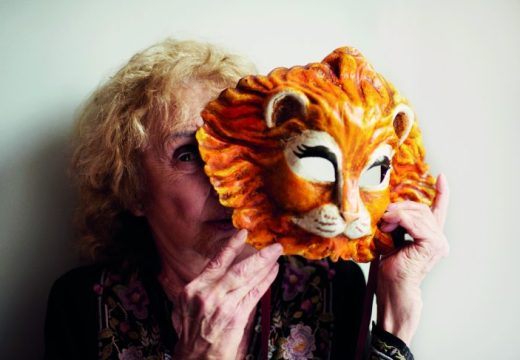 Carolee Schneemann holding a Venetian lion mask, photographed in London in May 2017, Photo: Benjamin McMahon