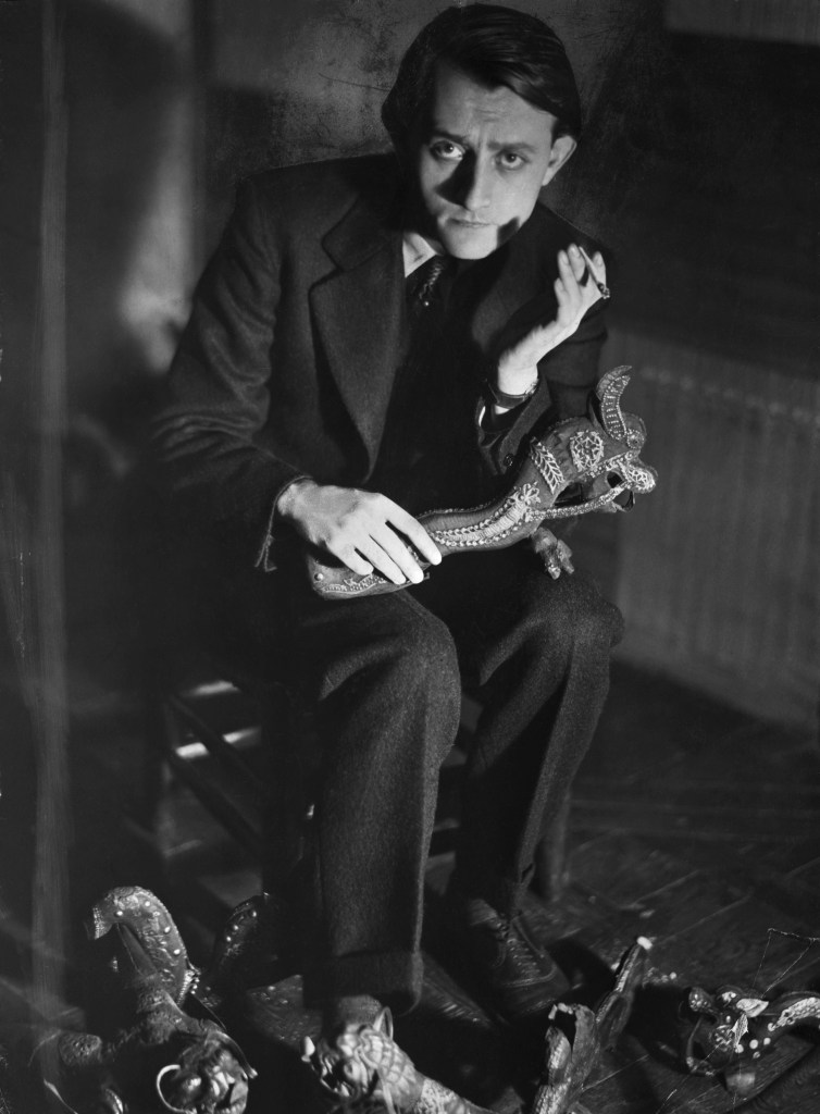 Andre Malraux holding a Khmer sculpture, Photo: © Bettmann/Getty Images