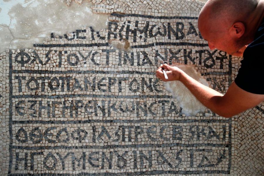 An archaeologist works on part of a 1,500-year-old mosaic discovered near Jerusalem's Damascus Gate, on 23 August 2017. AHMAD GHARABLI/AFP/Getty Images