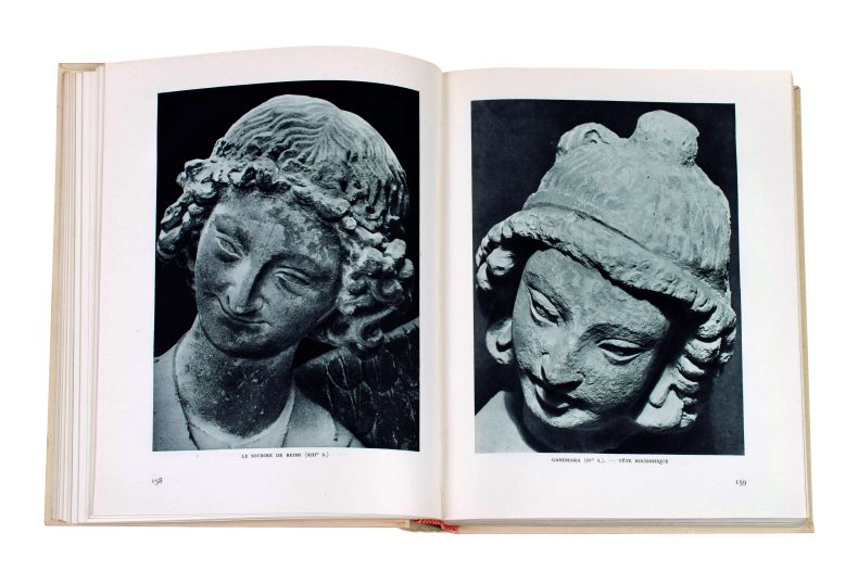 A spread from Les voix du siècle (1953) showing the 13th-century Le Sourire de Reims (verso) and a 4th-century Gandharan head from Afghanistan (recto). photo: Stephan Vavra