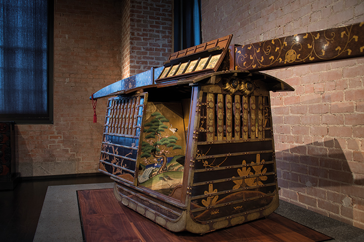 A 19th-century norimono or palanquin in the Ann & Gabriel Barbier-Mueller Museum, bearing the crest of the Tokugawa clan and decorated with trees and plants symbolising resilience and perseverance.