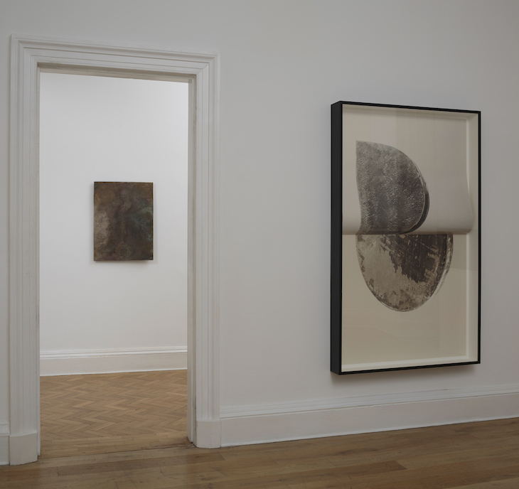 Installation view of 'Slow Objects' at the Common Guild, Glasgow, showing Vanessa Billy's Old Cloud (2017) and Erin Shirreff's Relief (no 3) (2015).