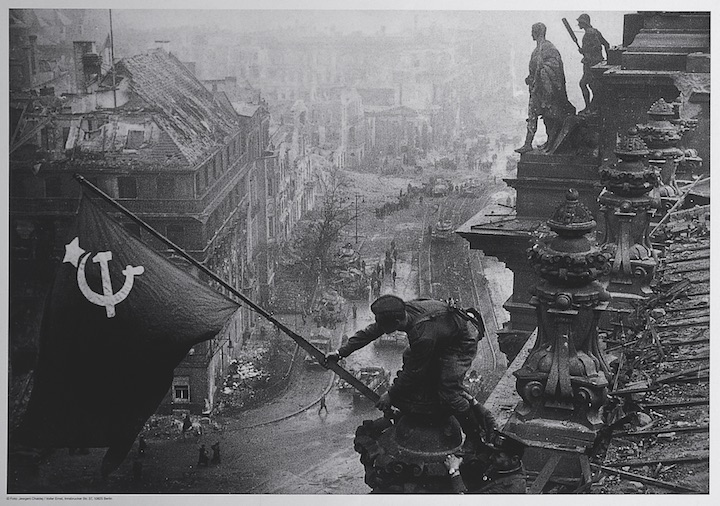 Soviet soldiers raising the red flag over the Reichstag, May 1945, Yevgeny Khaldei. The David King Collection at Tate