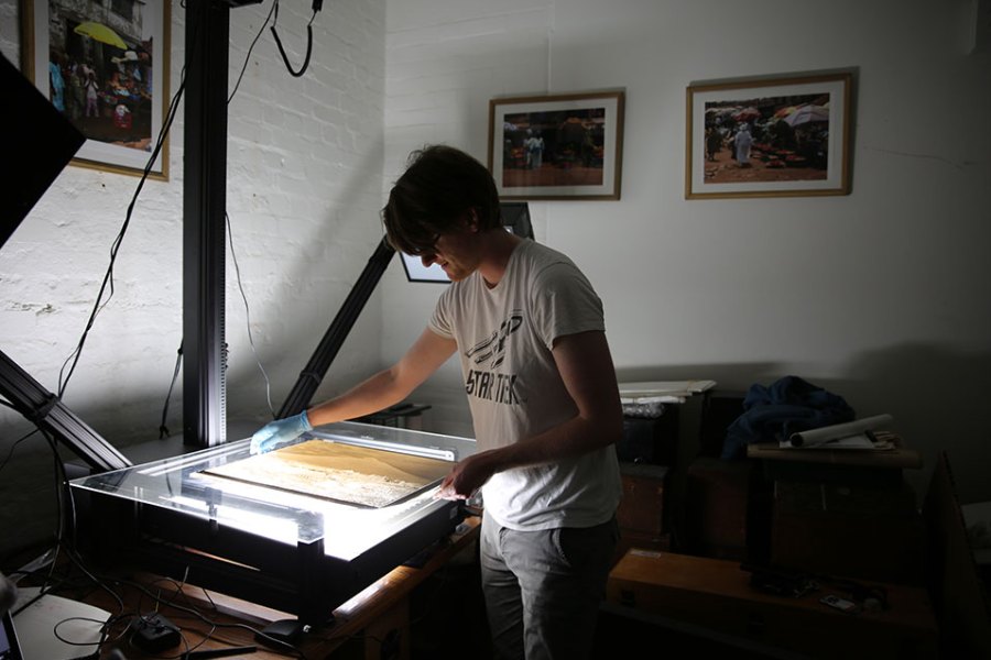British Museum assistant collections manager Jonny Mortemore using the glass plate negative scanner. Courtesy of the Trustees of the British Museum