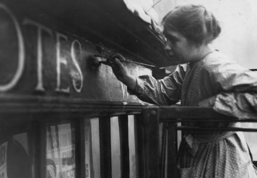 Sylvia Pankhurst painting onto the façade of the Women's Social Defence League shop in Bow Street, London (11 October 1912).