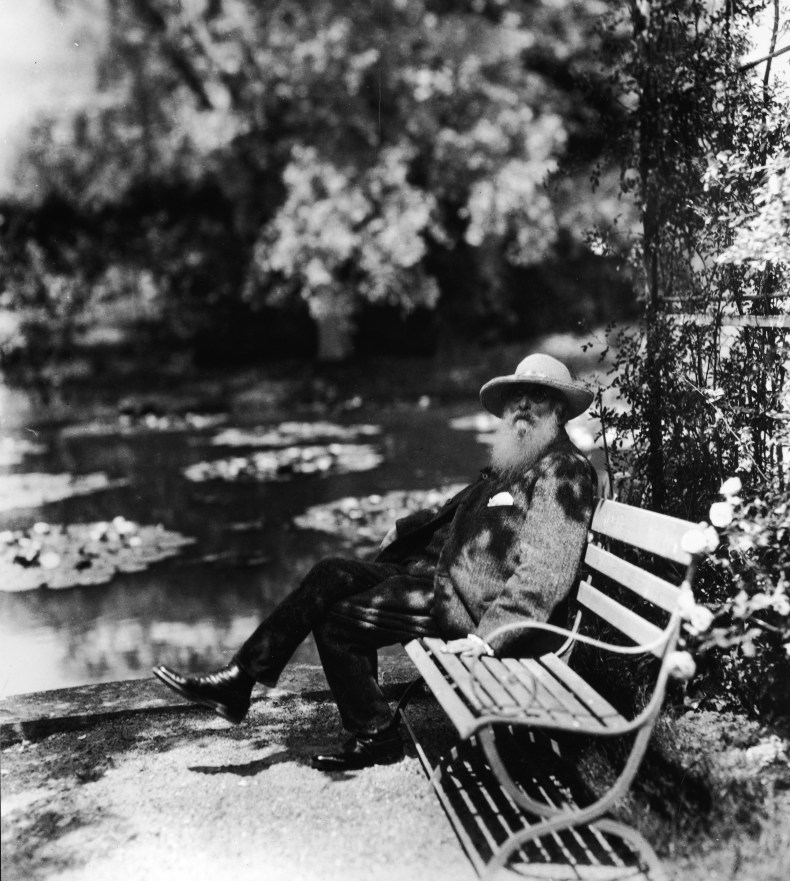 Claude Monet sitting on a bench beside the water lily pond in his garden at Giverny, 1910s, photo: Hulton Archive/Getty Images