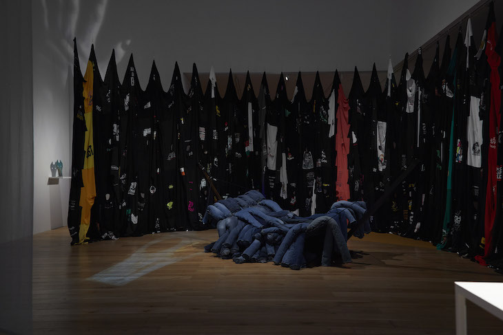 Installation view, Vicky’s Blue Jean Hammock 2 (2018) in front of Fade into Black (2017) by Pia Camil, Nottingham Contemporary, 2018.