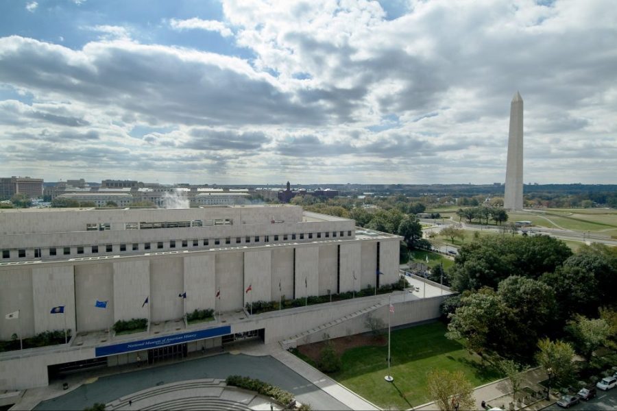 The Smithsonian's National Museum of American History, Kenneth E. Behring Center in Washington, D.C., with the Washington Monument and National Mall in the background.