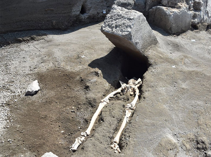 The skeleton of a man crushed by a block of stone, discovered during excavations of Regio V.