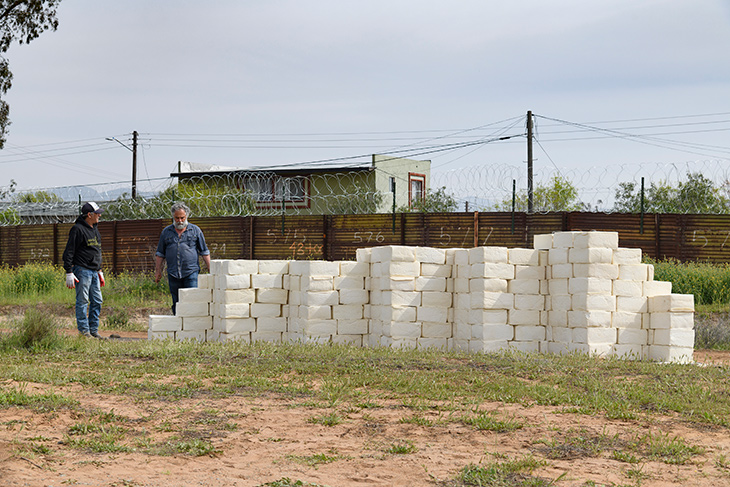 Artist Cosimo Cavallaro building his wall of cheese.