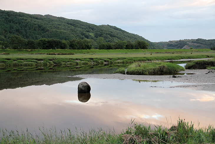 Wooden Boulder (1978–ongoing) in the Dwyryd estuary, 2013. Photo: courtesy the artist; © David Nash
