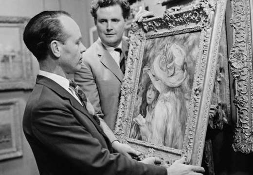 An art adviser, Graham Reid, examines a painting (Les Deux Soeurs) by Pierre-Auguste Renoir before its auction at Sotheby’s in London in 1963.