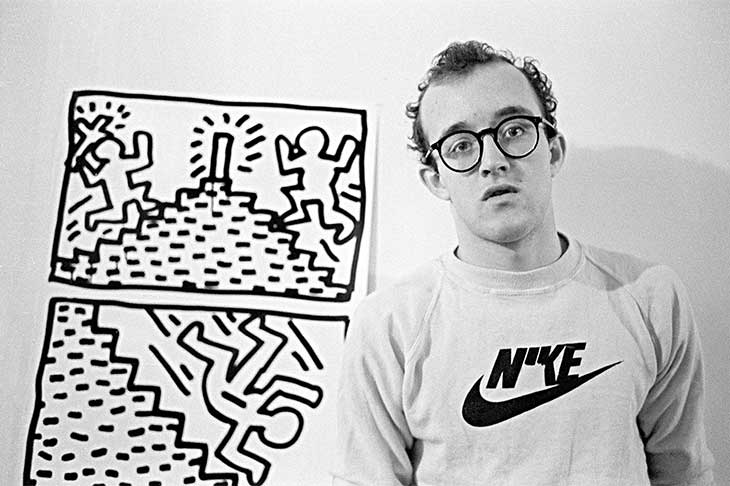 Keith Haring with one of his drawing series, photographed in January 1982 by Joseph Szkodzinski.