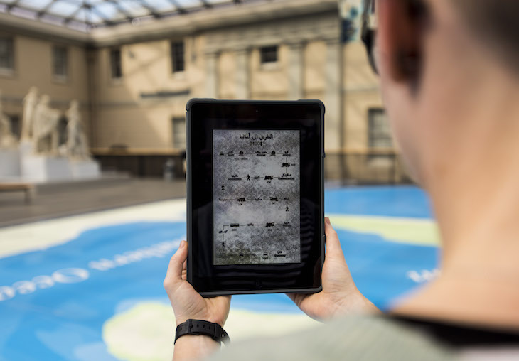 Curator Megan Barford holding the Road to Germany map on an iPad.