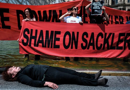 Nan Goldin protesting with P.A.I.N. in the courtyard of the Louvre in July 2019.