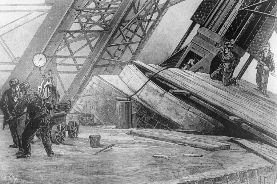 Workmen riveting the bases of the Eiffel Tower in place using hydraulic power in c. 1888.