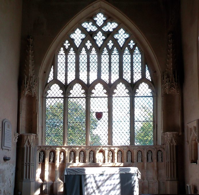 The east chancel wall, featuring a limestone reredos from the late 14th century, of the Parish Church of the Assumption of the Blessed Virgin Mary at Harlton, Cambridgeshire. Photo: © James Alexander Cameron