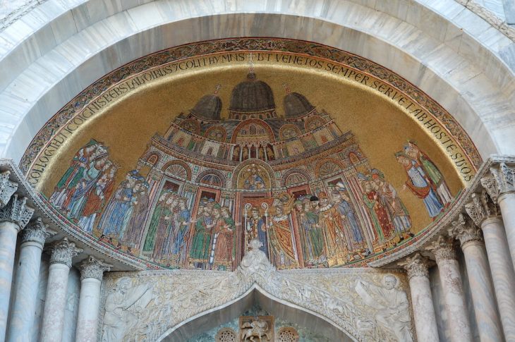 View of the 13th-century mosaic depicting the arrival of the body of St Mark in Venice, above the left-hand portal of the facade of San Marco in Venice.