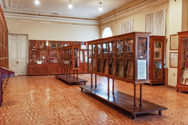 Cabinets designed by Alexander Szymkiewicz and (far wall) the display of jejims in the State Silk Museum, Tbilisi.