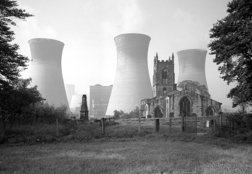 View of Ferrybridge B power station behind the Church of St Edward the Confessor in Brotherton, North Yorkshire, photographed by Eric de Maré in 1960. Photo: © Eric de Maré/RIBA collections
