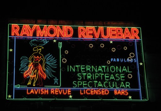 Neon sign made in the 1950s for Raymond Revuebar in Soho, London, photographed in 2015 after restoration and reinstallation.