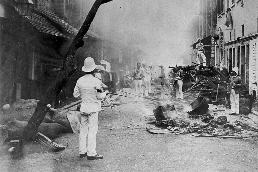 Shropshire Regiment ‘Whitewash Brigade’ emptying items from Chinese homes in Taipingshan, Hong Kong, and burning them on the street as an epidemic control measure during the 1894 plague outbreak.
