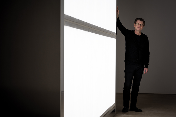 Alfredo Jaar photographed next to his installation ‘The Sound of Silence’ (2006) at Yorkshire Sculpture Park in October 2017. Photo by Jonty Wilde